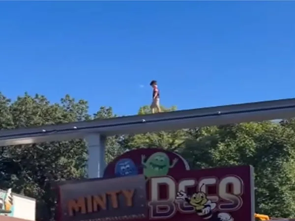 Niño caminando sobre monorriel en parque de diversiones de Estados Unidos.