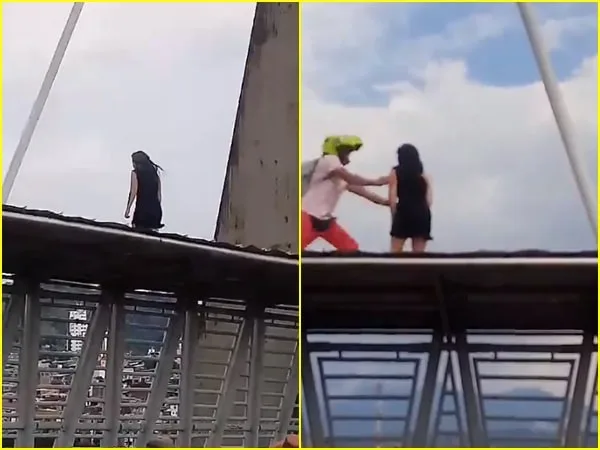 Mientras la comunidad intentaba persuadir a la mujer para que no se lanzara, un policía vestido de civil subía por el viaducto para socorrerla.