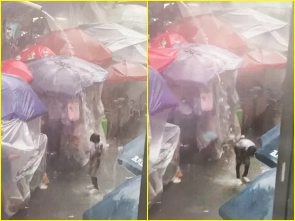 Con la ropa puesta y bajo la lluvia, el habitante de calle no desaprovechó la oportunidad para darse un buen baño
