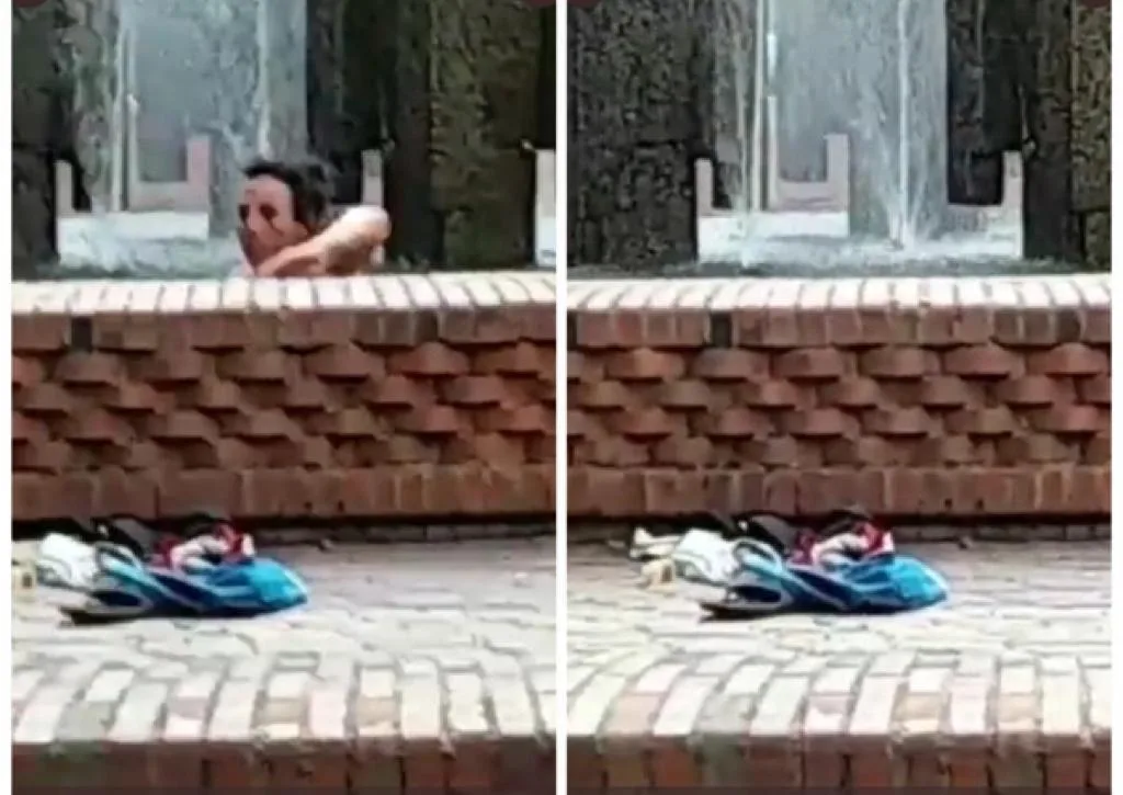 mujer bañandose en fuente en Cali